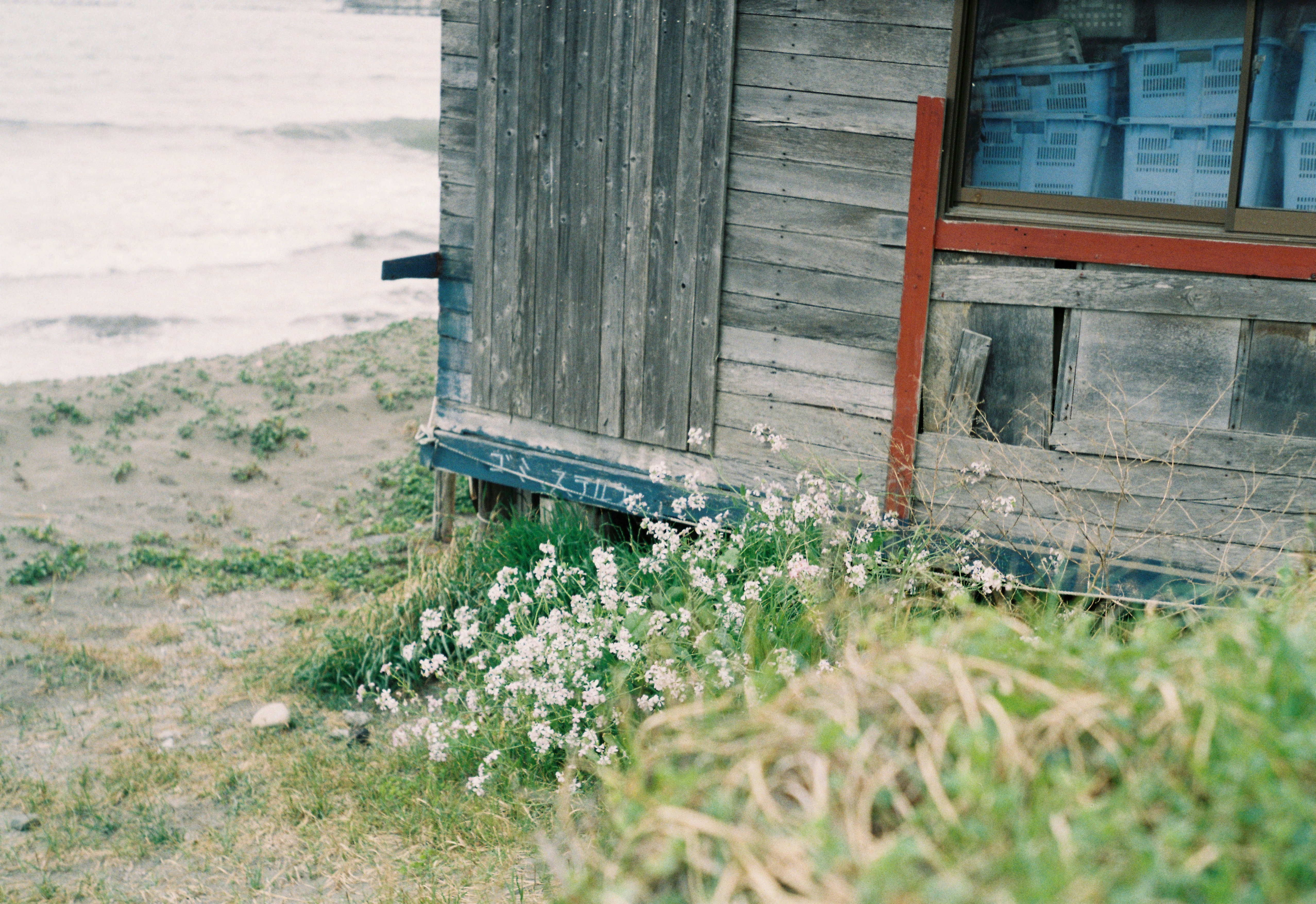 a wooden building sitting next to a body of water