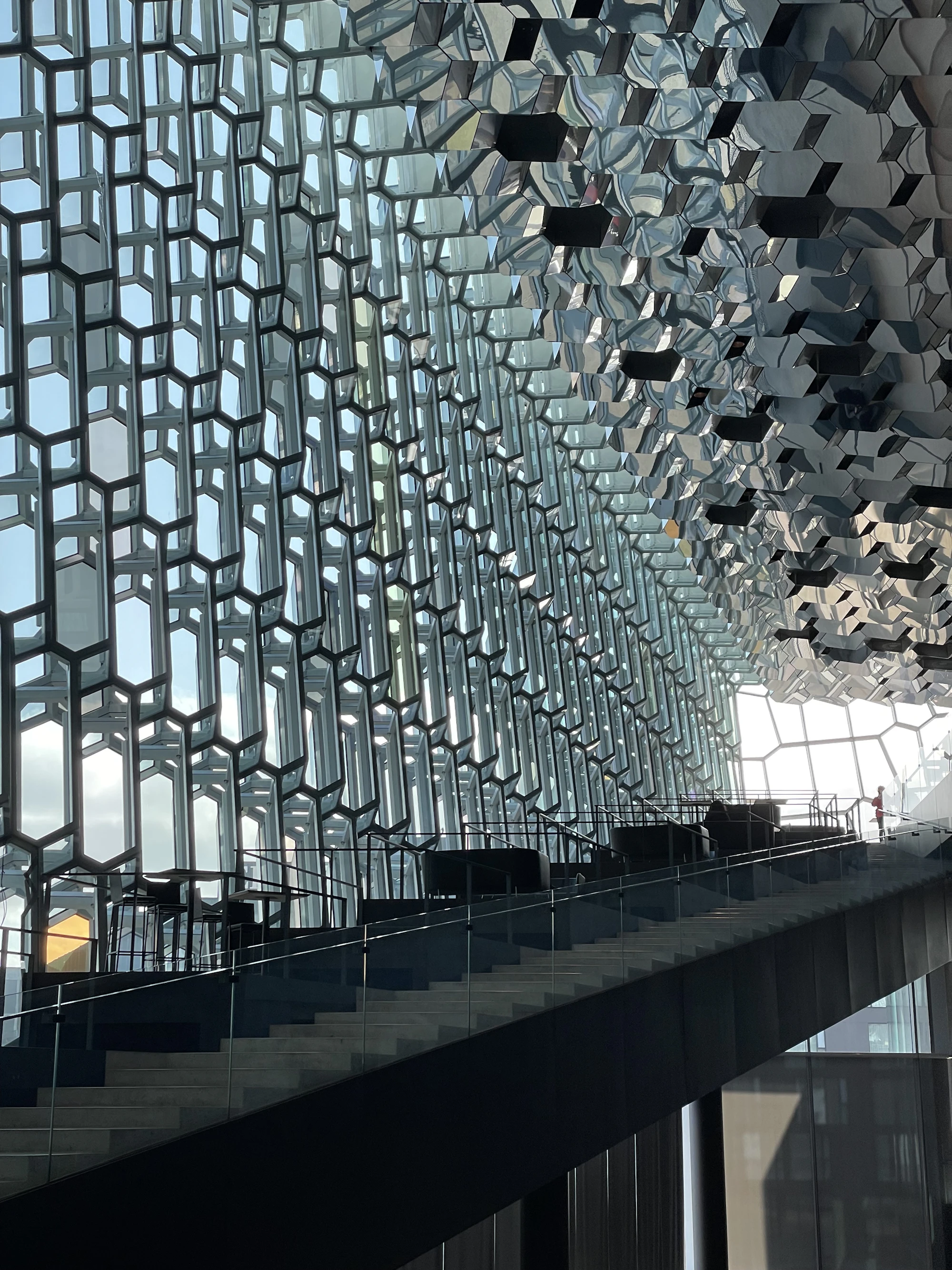 A facade of hexagonal glass panels seen from inside