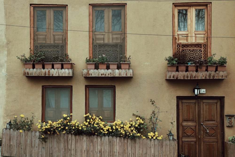 a building with a wooden fence and flower boxes on the windows