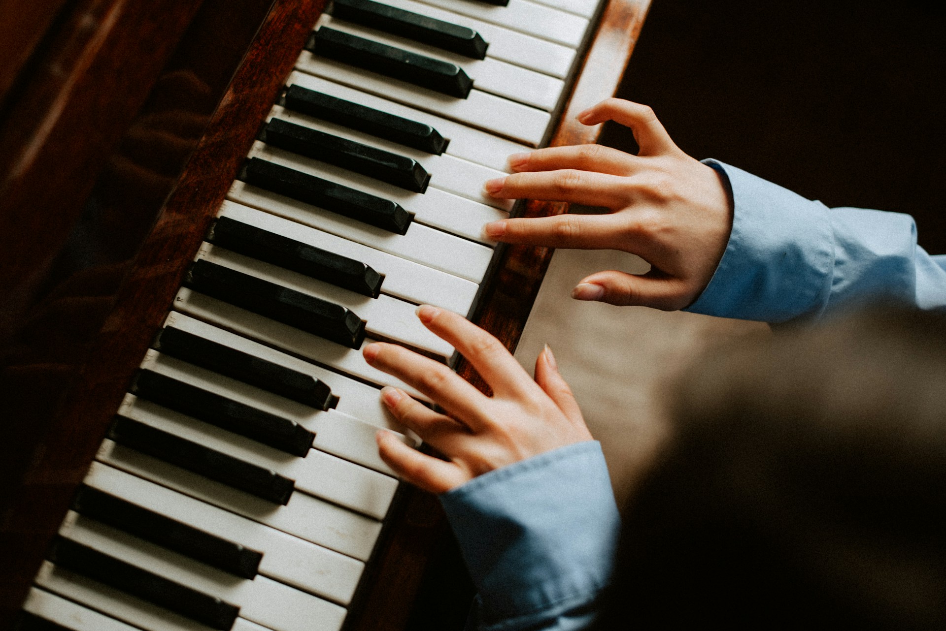 a person playing a piano with their hands