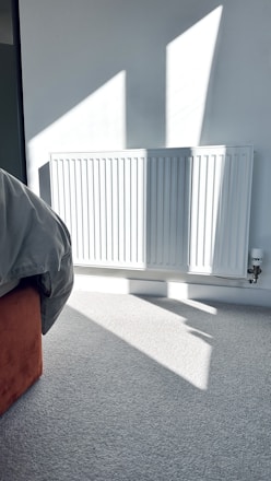 a bedroom with a radiator and a bed in it