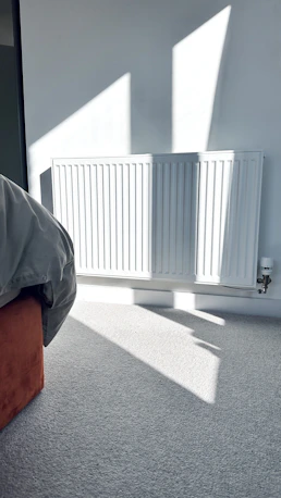 a bedroom with a radiator and a bed in it