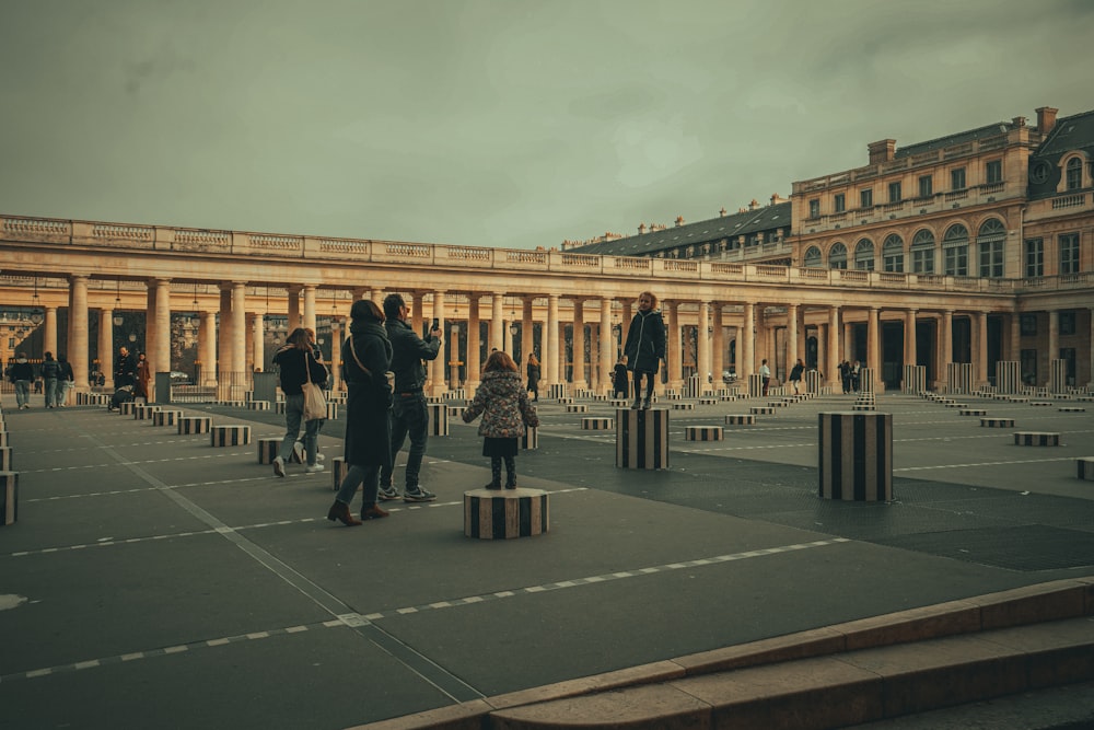 a group of people standing around in a courtyard