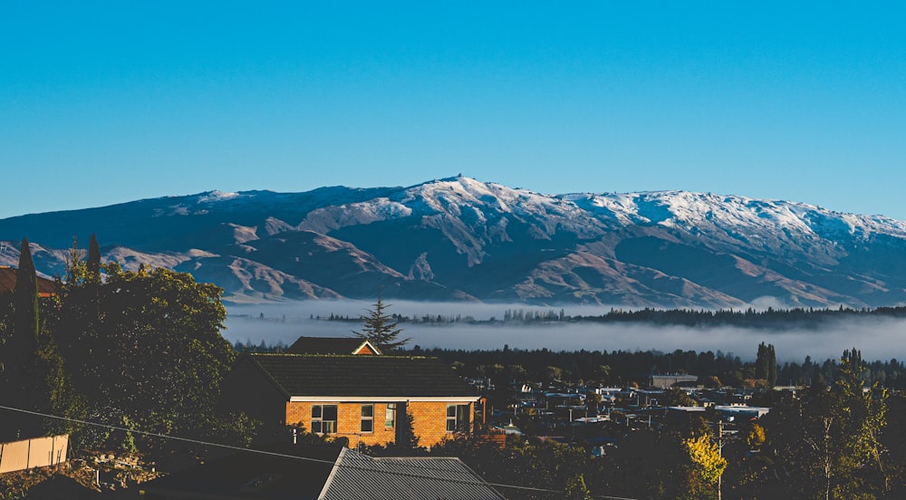 a view of a mountain range with houses in the foreground