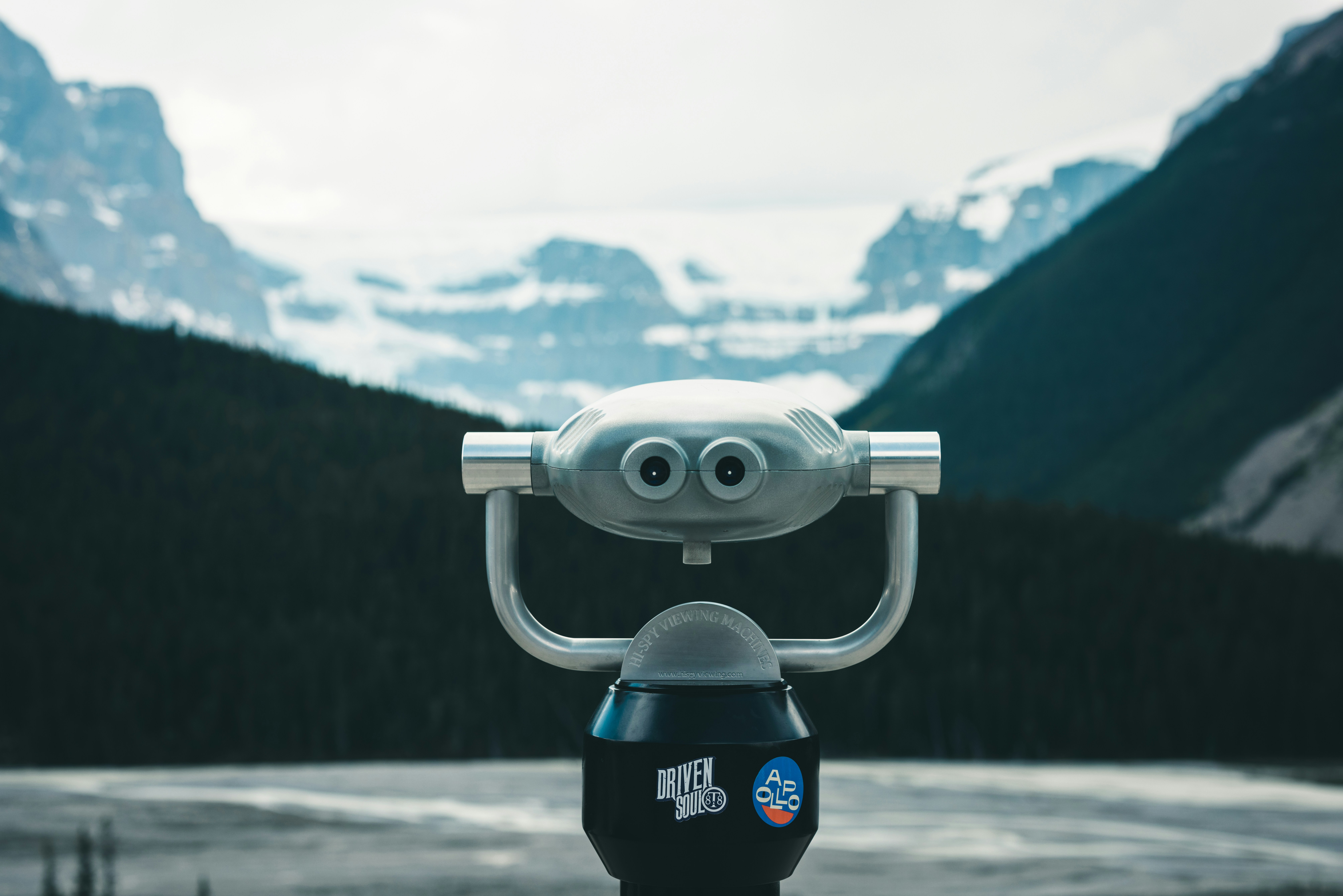 a close up of a camera with mountains in the background, Icefields watching