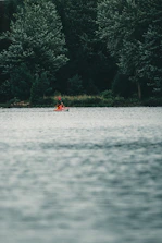 An instructor helping a beginner kayak smoothly through gentle tidal waters.