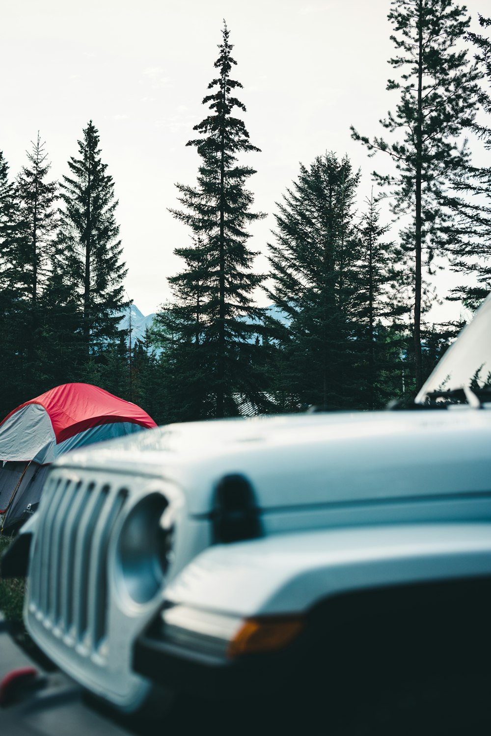 a jeep is parked next to a tent