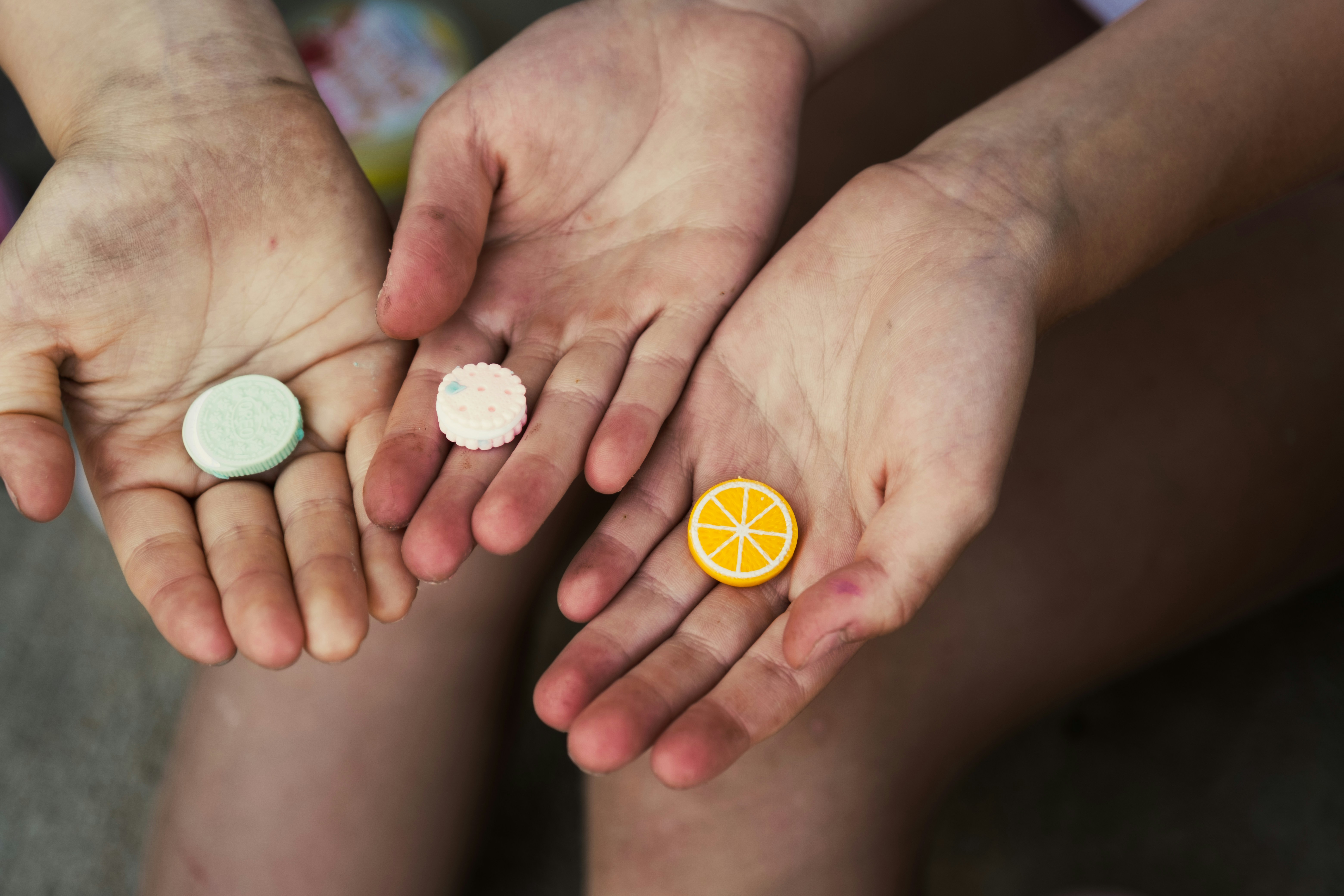 a couple of people holding a slice of orange