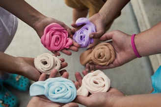 a group of people holding different colored flowers