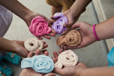 a group of people holding different colored flowers