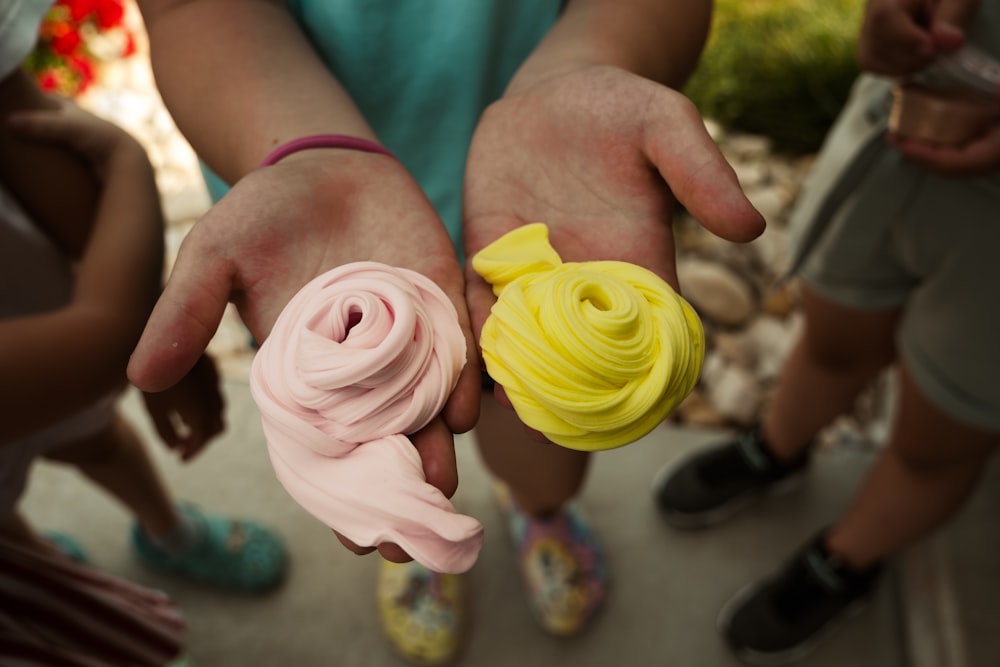 a close up of a person holding a small object in their hands