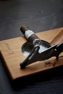 a cigar sitting on top of a cutting board