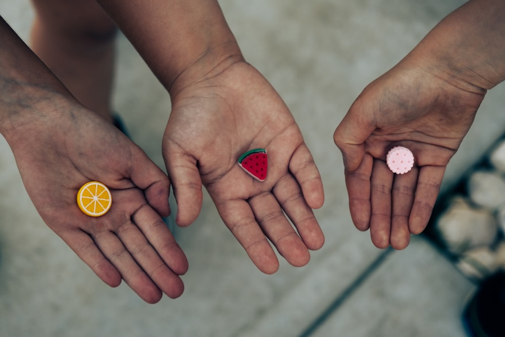 a couple of people that are holding some fruit