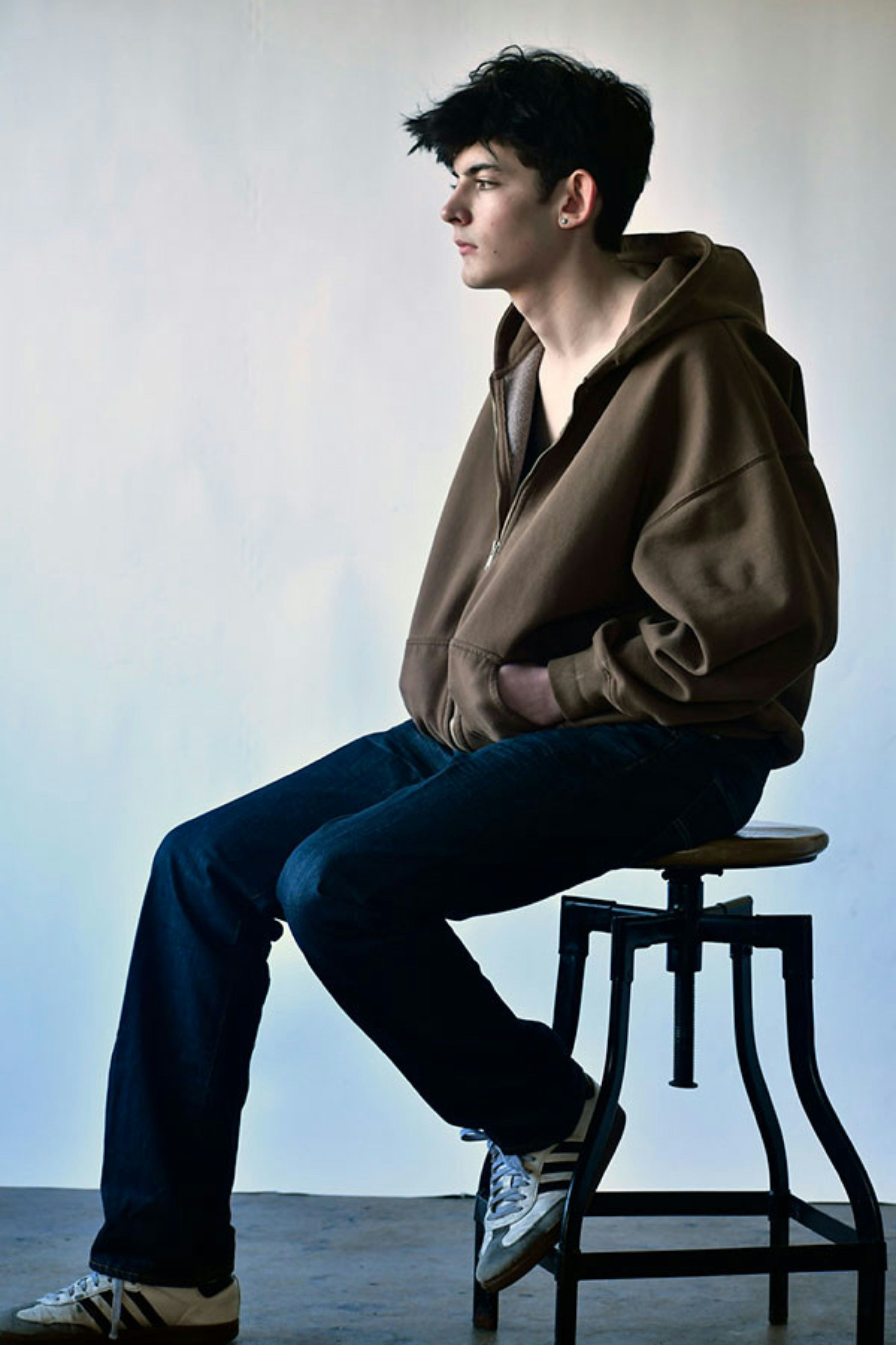 a man sitting on top of a stool