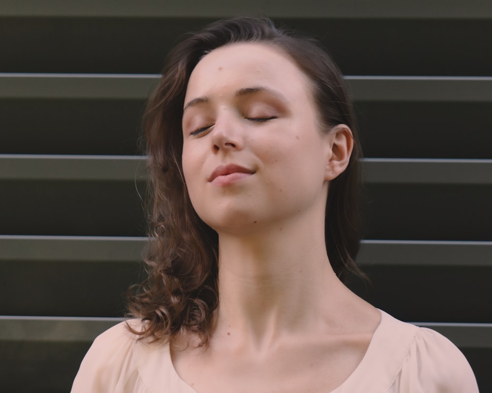 a woman with her eyes closed and her eyes closed