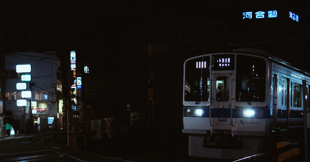 a subway train on a city street at night