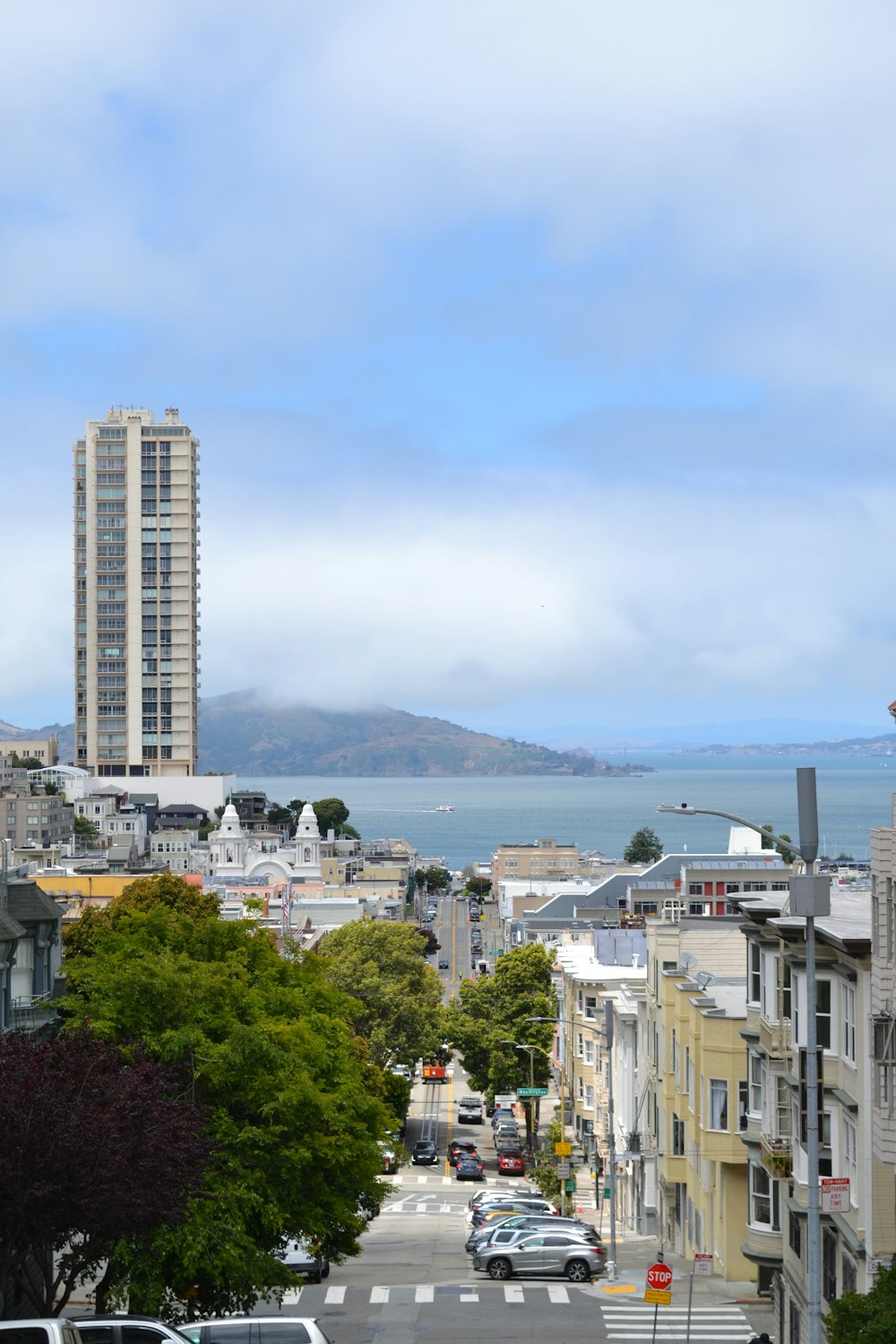 a view of a street with cars parked on the side of it