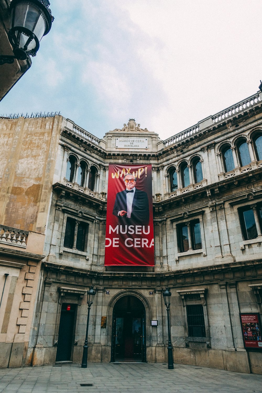 a large building with a red banner hanging from it's side