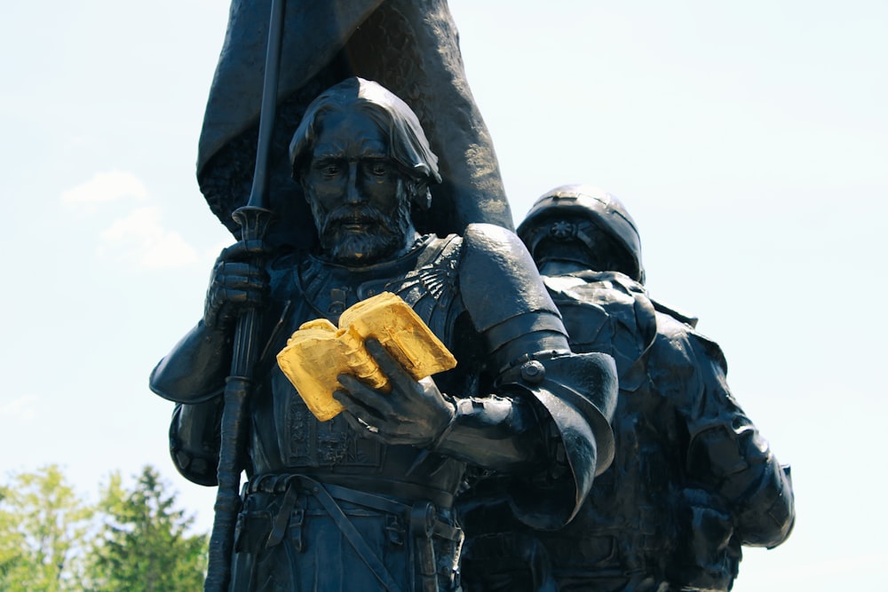 a statue of a soldier holding a yellow object
