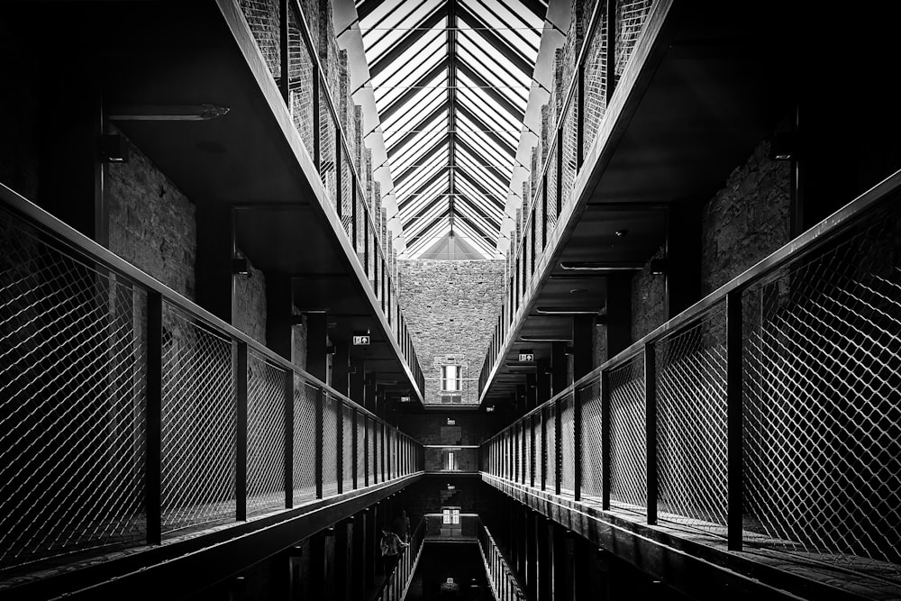 a black and white photo of a long hallway