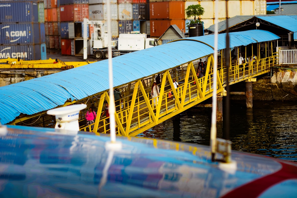 a yellow bridge over a body of water