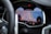 A close-up view of a car's digital dashboard displaying a navigation system. The map on the screen shows roads, parking symbols, and the temperature outside. The dashboard features sleek, modern design elements with a focus on functionality.