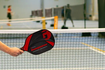 A professional corporate pickleball tournament with teams competing on sleek courts.