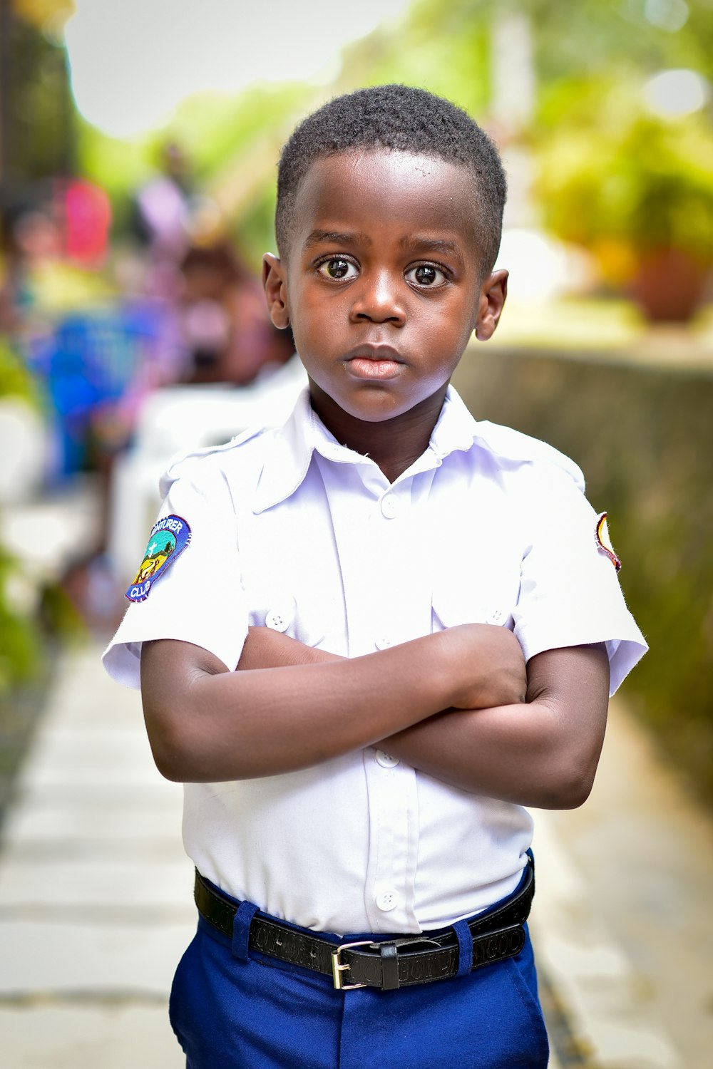 a young boy in a white shirt and blue pants