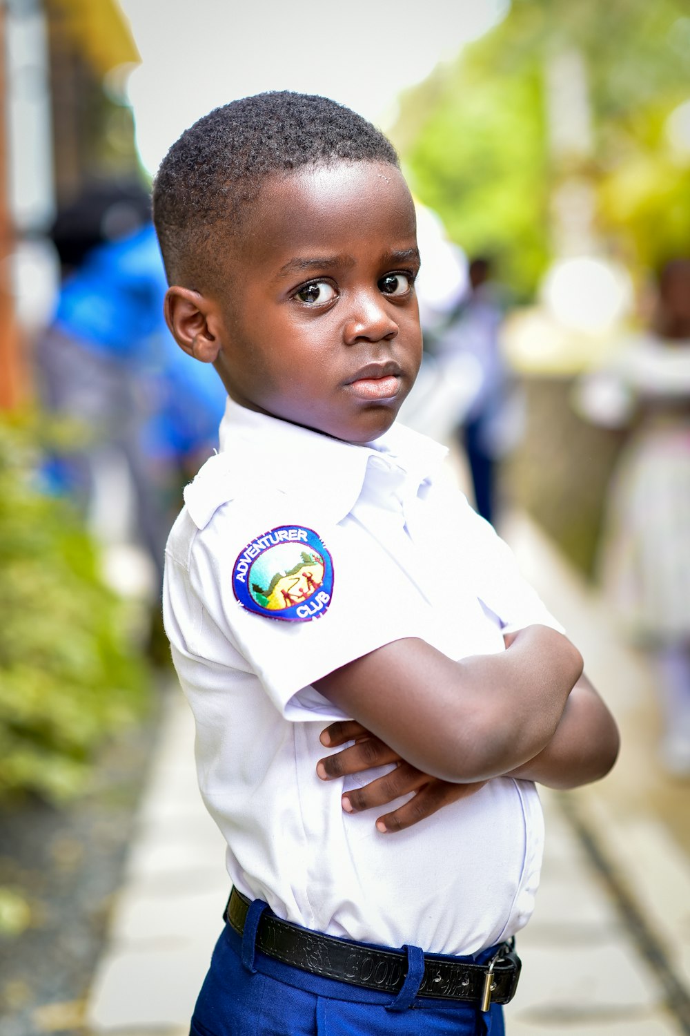 a young boy in a uniform is posing for a picture