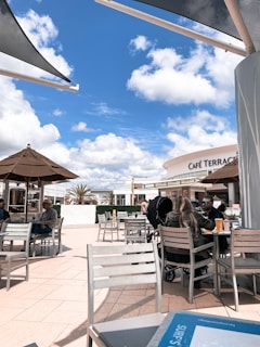 An inviting café terrace with patrons enjoying their drinks.