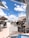 Outdoor restaurant terrace with customers enjoying food and drinks.