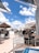Outdoor restaurant terrace with customers enjoying food and drinks.