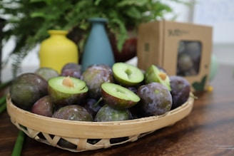 Close-up of hands unboxing a fresh shipment of plumsville products with care.