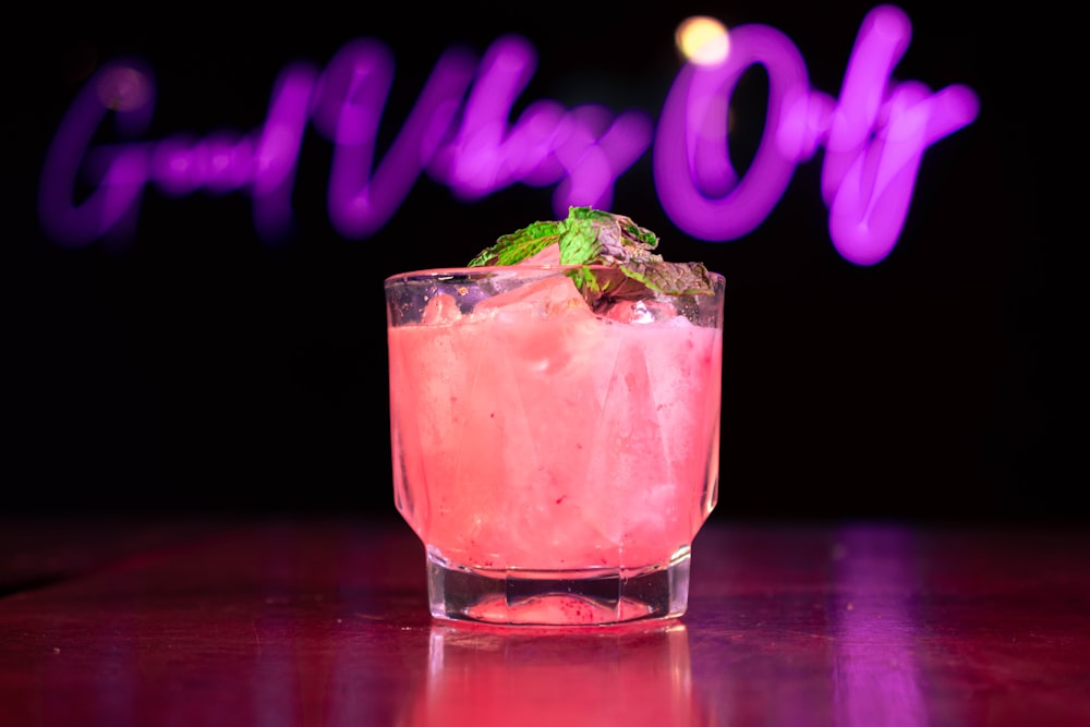 a pink drink sitting on top of a table