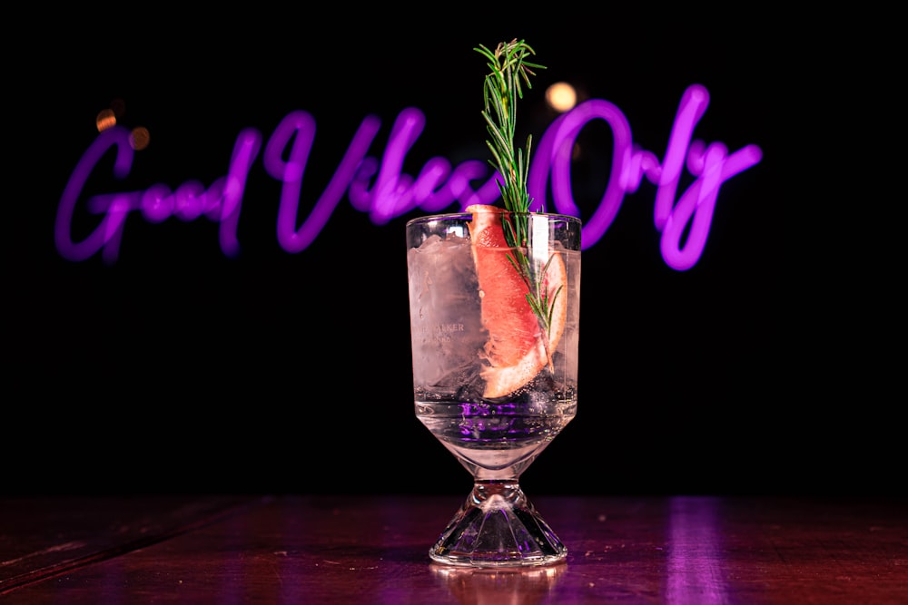 a glass filled with ice and garnish on a table