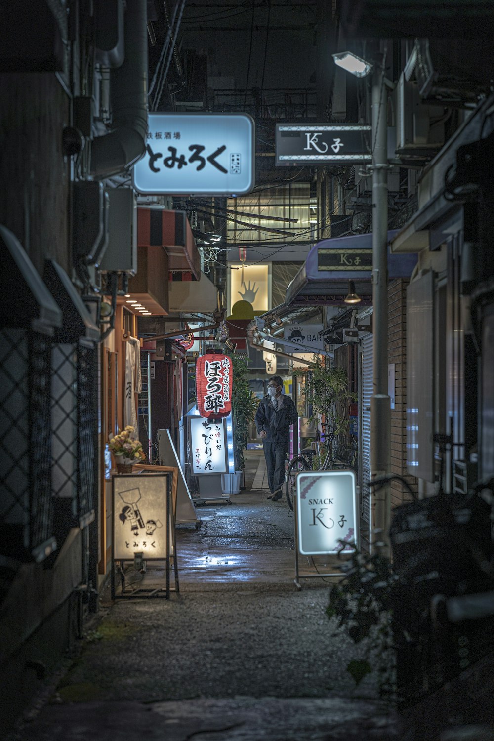 a narrow alley way with signs and signs on it