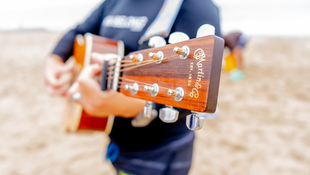 a close up of a person holding a guitar