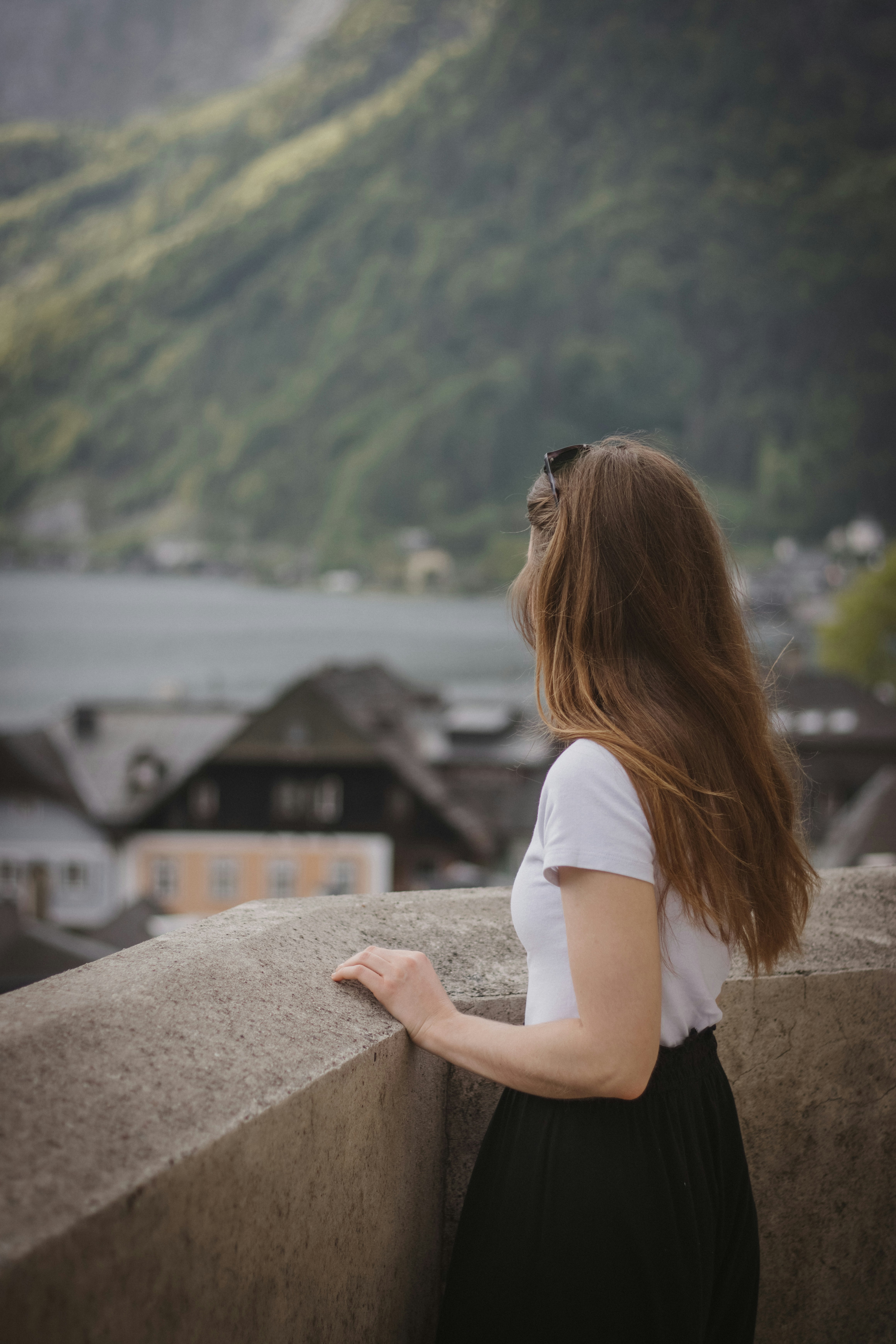 a woman standing on top of a cement wall