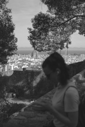 A dynamic black and white photo of a travel influencer capturing a scenic landscape with a camera in Perth.