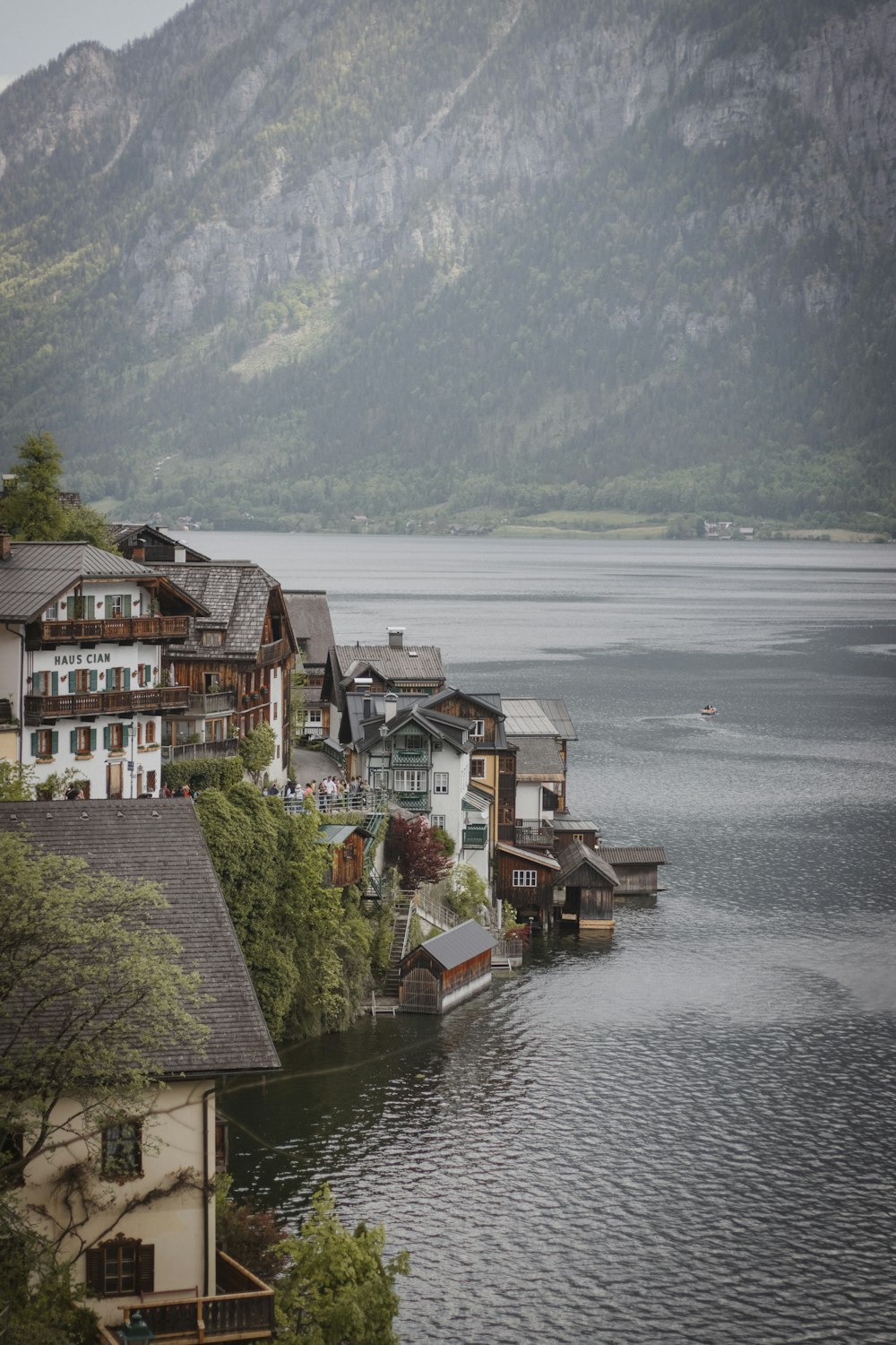 a body of water surrounded by houses and mountains