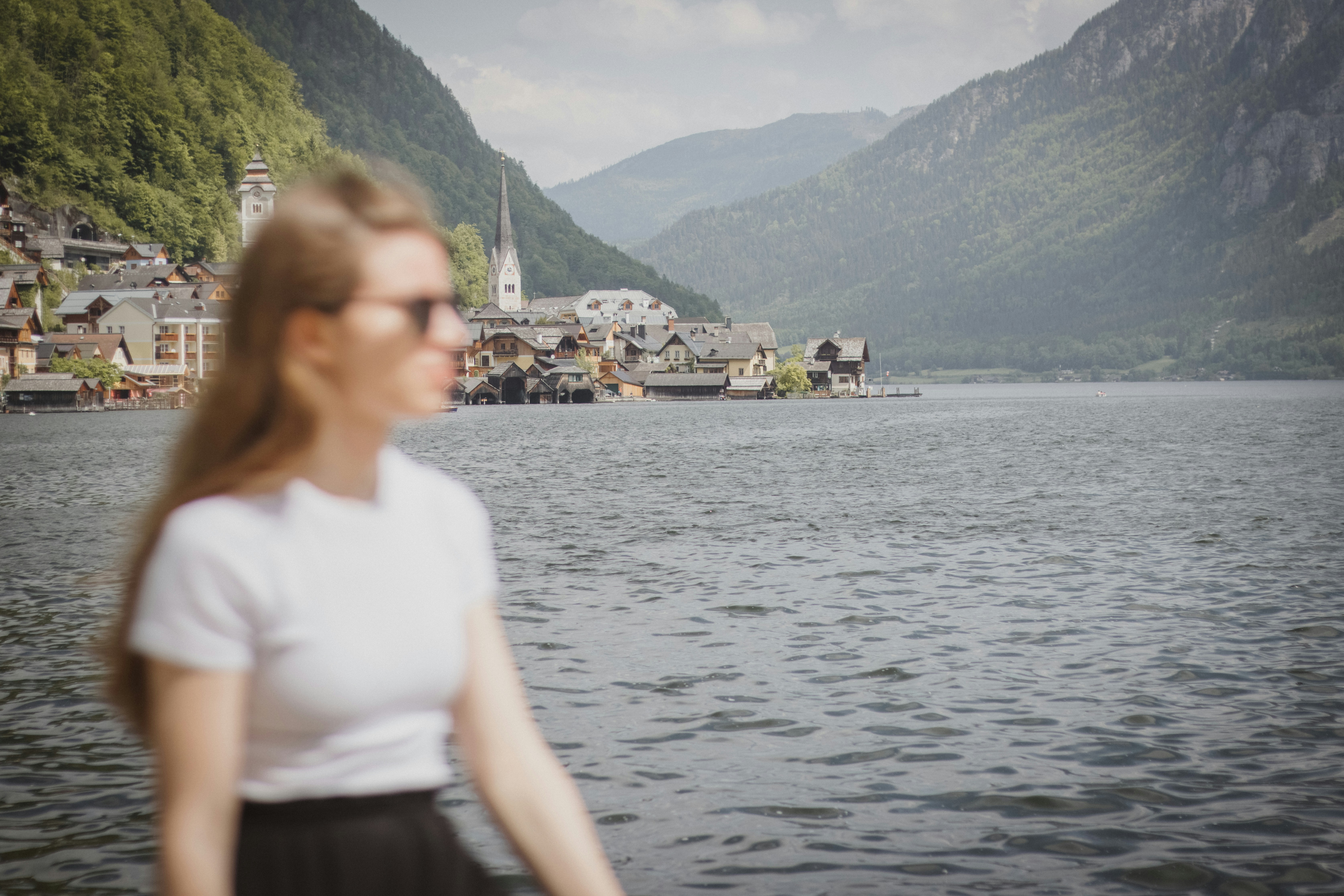 a woman standing in front of a body of water
