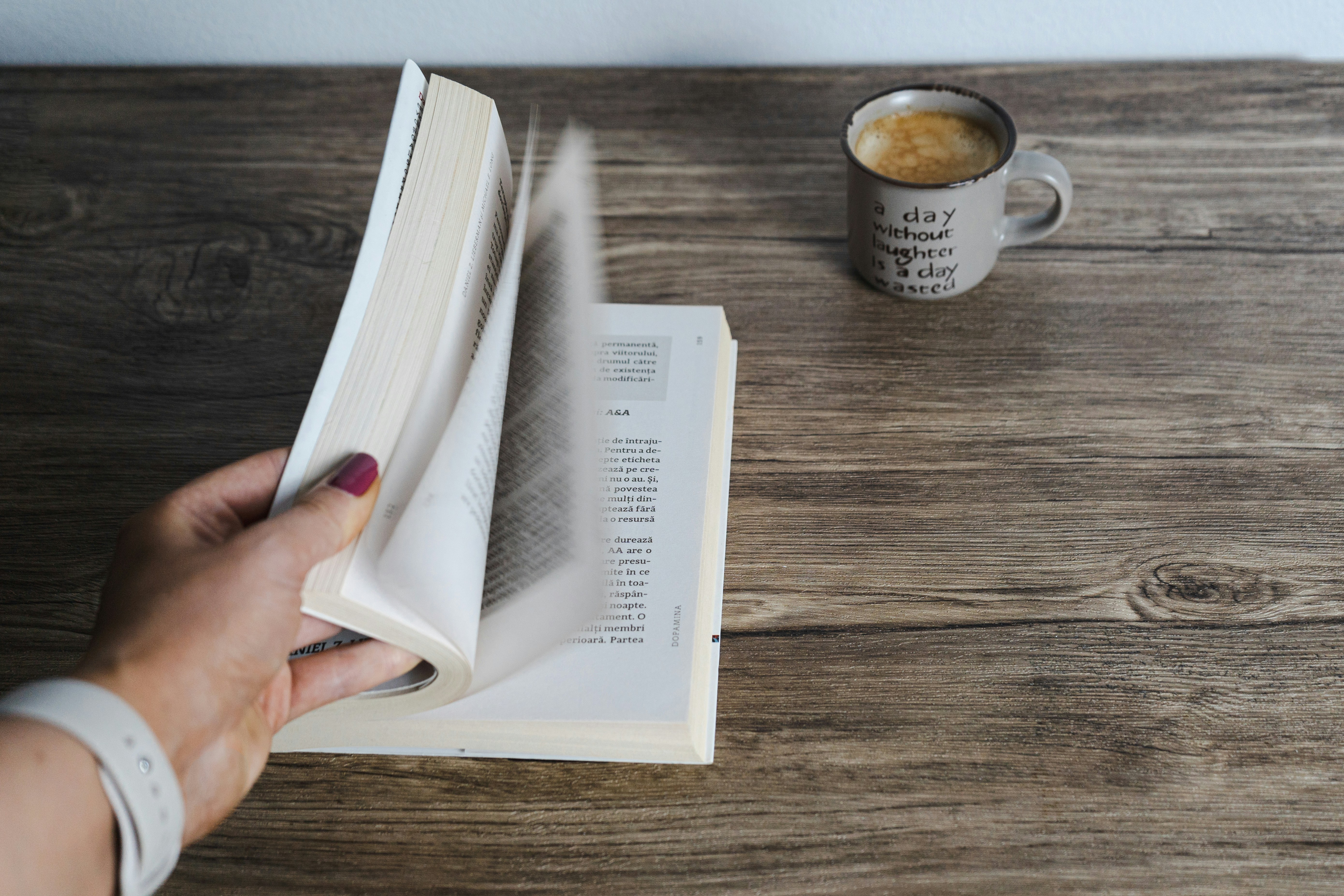 Person reading book with coffee