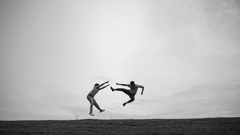 a couple of people that are jumping in the air