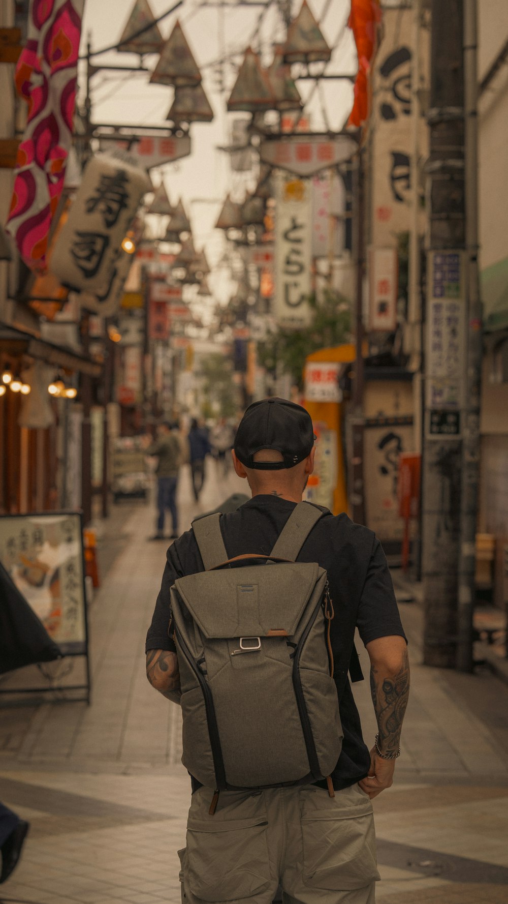 a man with a backpack walking down a street