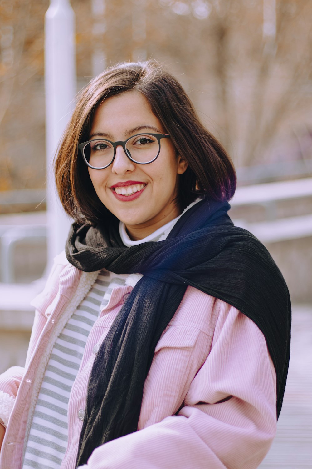 a woman wearing glasses and a scarf