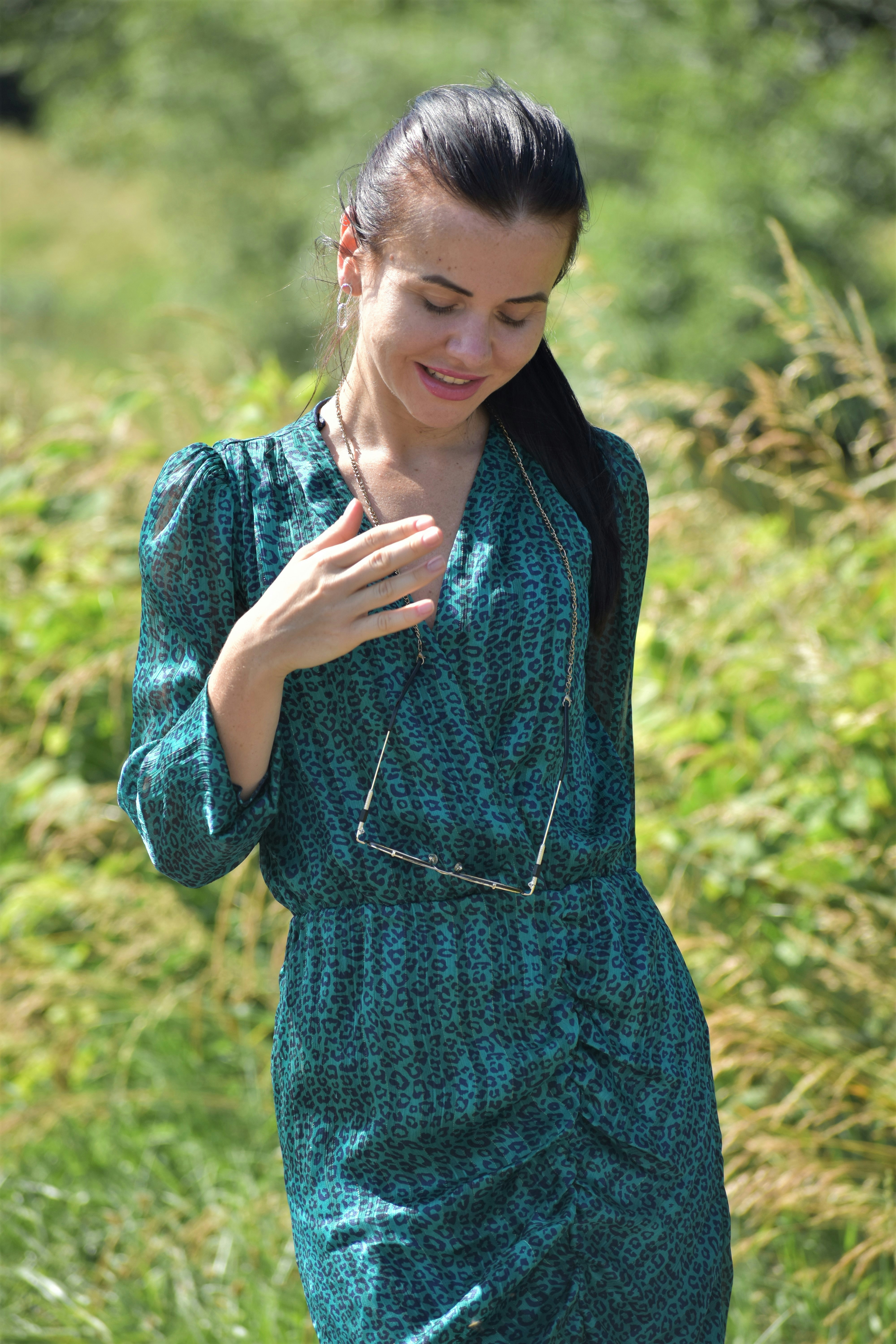 Happy woman in colorful stylish outfit, bright outdoor sunny setting