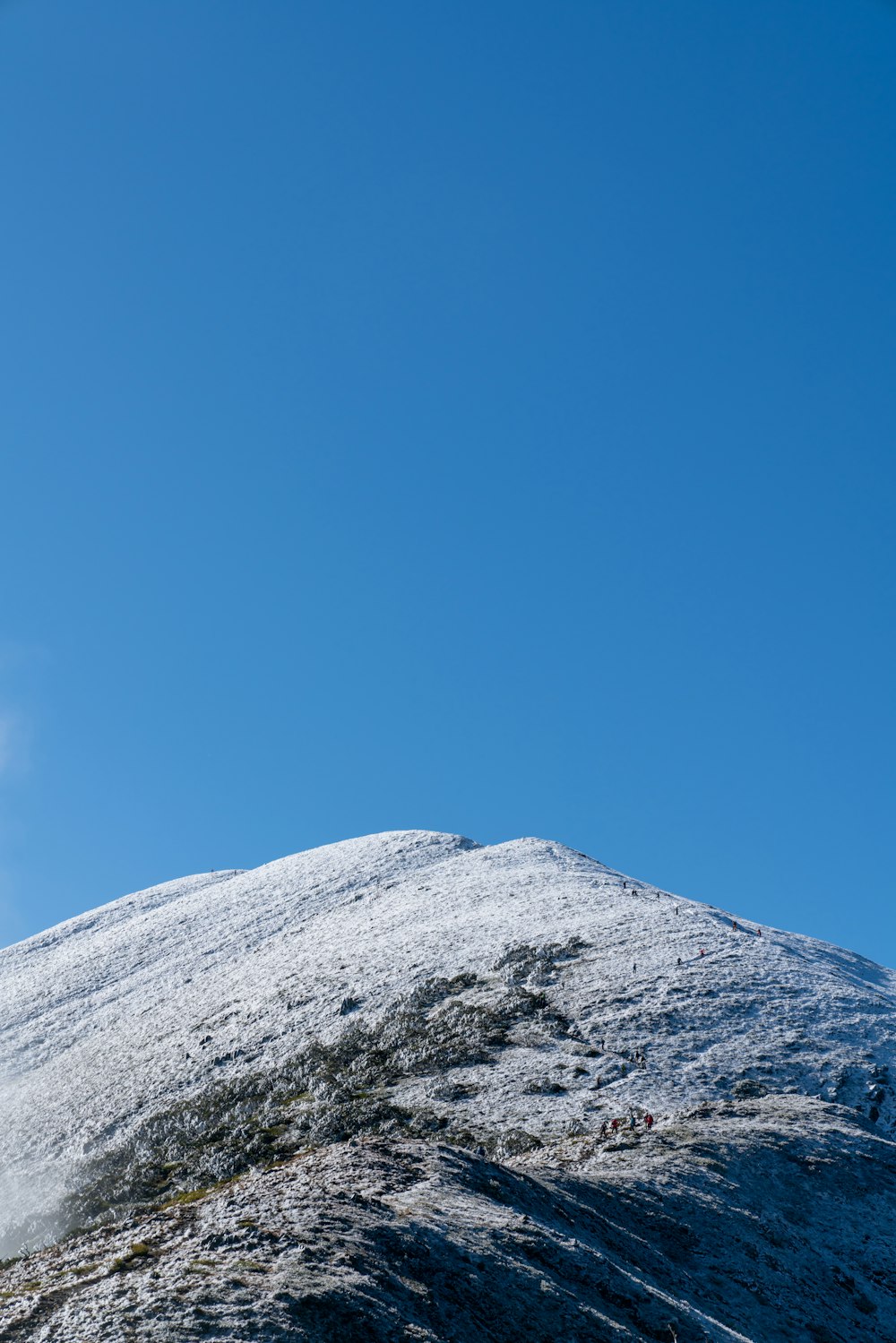 a person on a snowboard on a snowy mountain