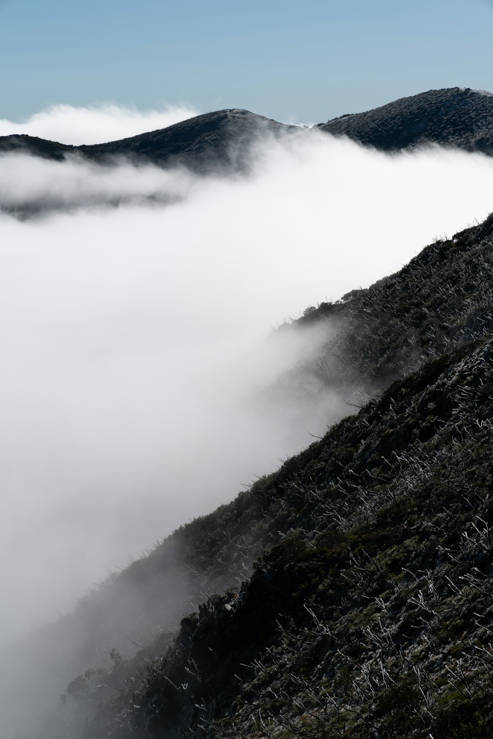 a mountain covered in low lying clouds