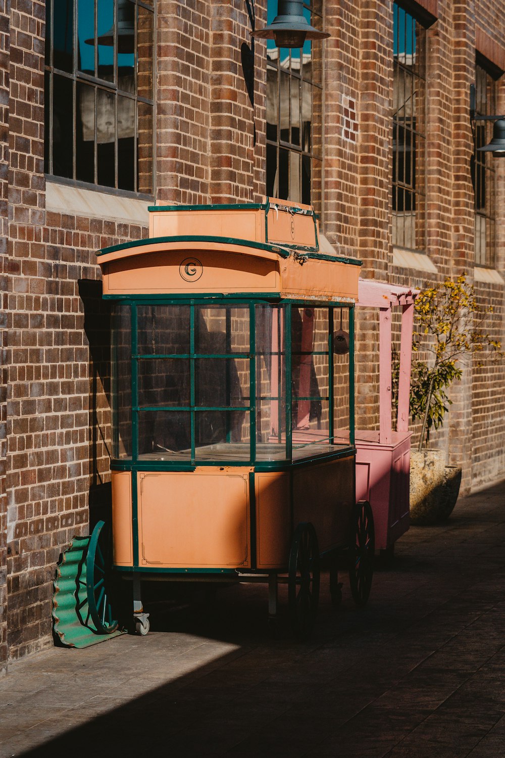 a trolley car parked next to a brick building