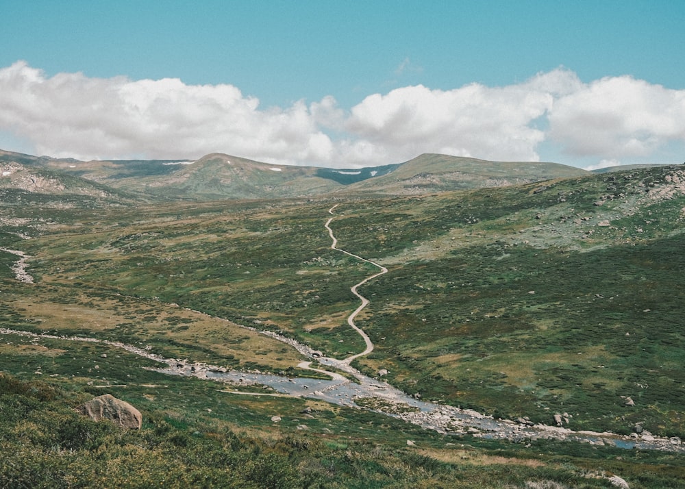 a winding road in the middle of a mountain range